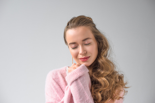 happy girl in pink shirt standing with closed eyes isolated on gray - Foto, Imagem