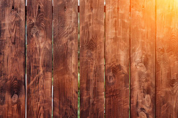 Brown, wooden board fence. Dark vintage wooden boards. Backgrounds and textures fence painted. Front view. Attract a beautiful vintage. - Фото, зображення