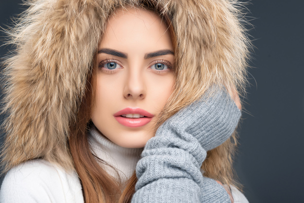 portrait of beautiful woman in fur hat and winter outfit, isolated on grey - Φωτογραφία, εικόνα