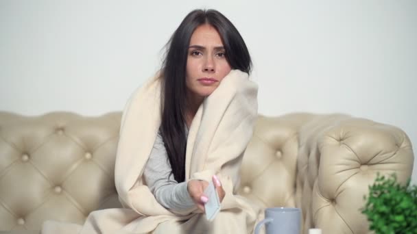 Sick young woman watching TV - Video, Çekim