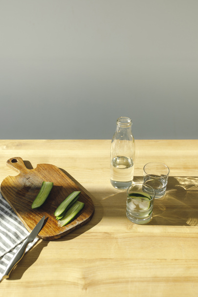 overhead view of preparing detox water with cucumbers - Fotó, kép