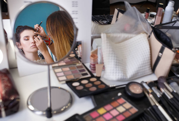 makeup artist doing make up for girl - Фото, изображение