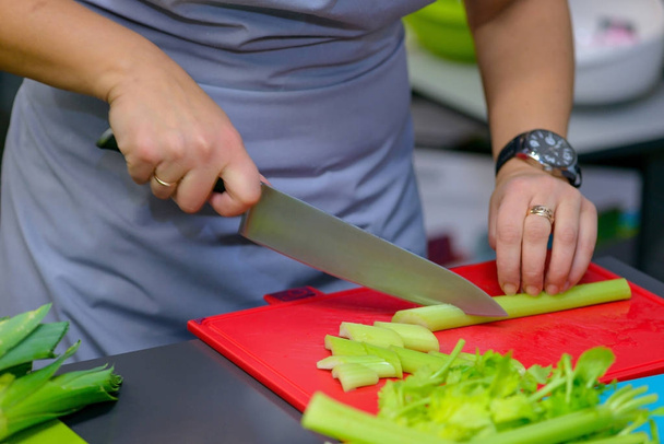 Femme coupe céleri dans la cuisine
 - Photo, image