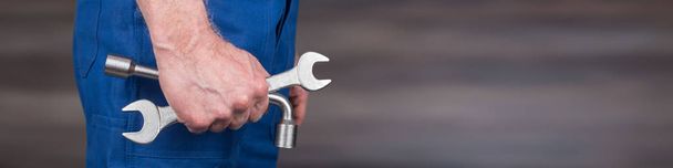 Hand of mechanic holding wrenches - Фото, зображення