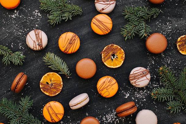 Pattern with oranges, macaroons and fir branches on a gray background  - Φωτογραφία, εικόνα
