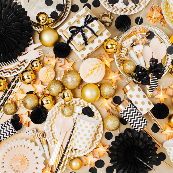 table setting decorated with Christmas balls and stuff in golden and black colors, flat lay, top view - Zdjęcie, obraz