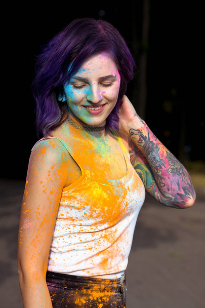 Portrait of lovely woman with purple hair and tattoo on her hand - 写真・画像