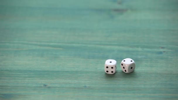 White small dices on wooden texture table - Felvétel, videó