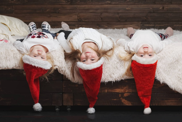 cute happy children with santa hats - Фото, изображение