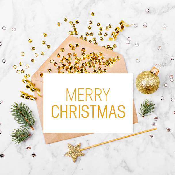Merry Christmas card and envelope with beautiful decorations: fir branches, golden confetti, streamers and ball - Fotó, kép