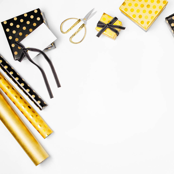 flat lay of golden presents and wrapping paper on white background  - Φωτογραφία, εικόνα
