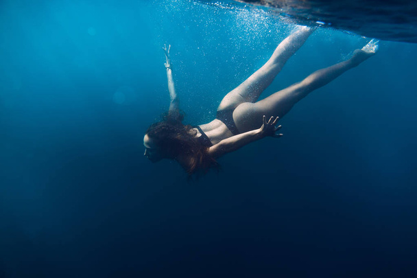 Woman  floating in quiet ocean. - Фото, зображення