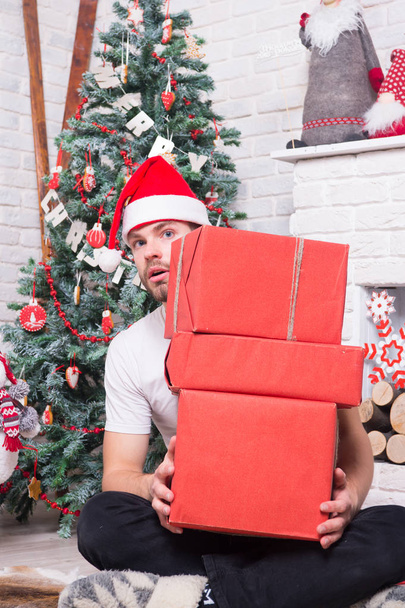 Man santa with boxes at christmas tree - Foto, Imagen