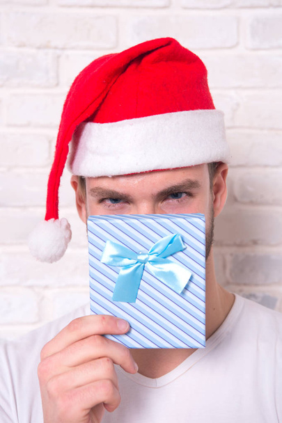 Man peep over present box with blue ribbon - Φωτογραφία, εικόνα
