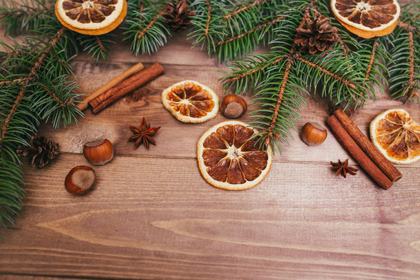 Christmas or New Year brown wooden background, Christmas food decor with fir tree.Xmas decorations, space for a text, view from above - Fotó, kép