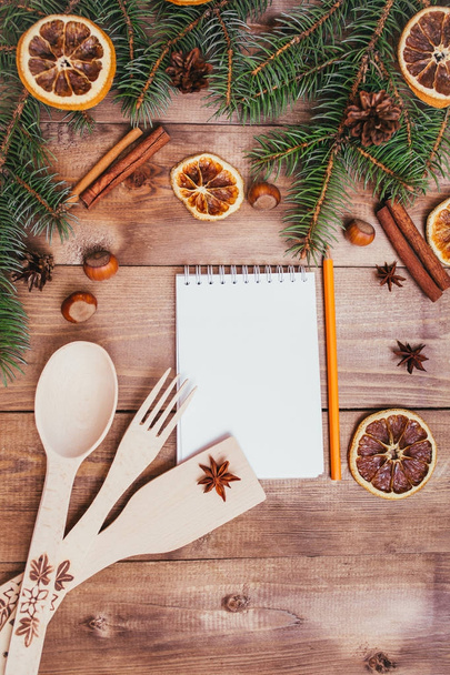 Christmas greeting card and food decor on wooden table with fir tree. Top view with copy space - Foto, Bild