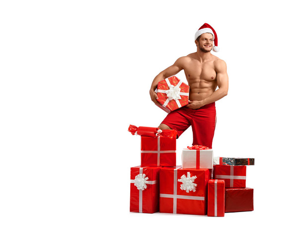 Sexy Santa Claus man with a pile of presents - Фото, изображение
