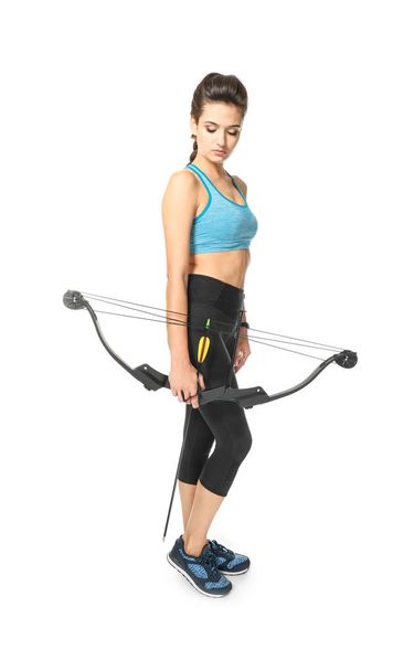 Sporty young woman with bow and arrow for practicing archery on white background - Foto, Bild
