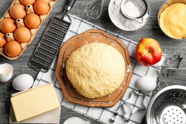 Raw dough and ingredients on kitchen table - Foto, Imagem