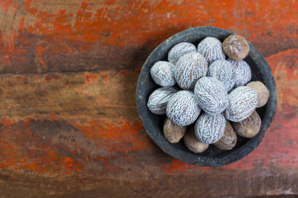 Maukas talvi mauste koko kuivattu muskottipähkinä, jota käytetään ainesosana monissa astioissa, munatoti, glögi, lähikuva vanhasta puupöydästä
 - Valokuva, kuva