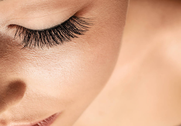 Beautiful young woman with eyelash extensions - Photo, Image