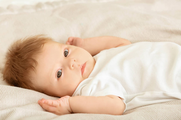 Cute little baby lying on bed  - Zdjęcie, obraz