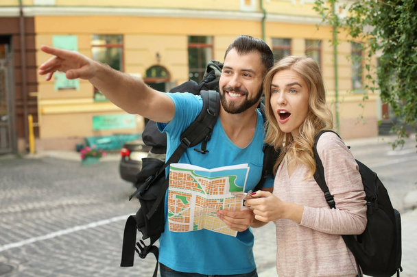 Couple of excited tourists with map on the street - Fotografie, Obrázek