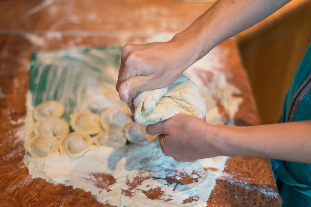 Female hands make home dumplings, close-up. - Photo, image