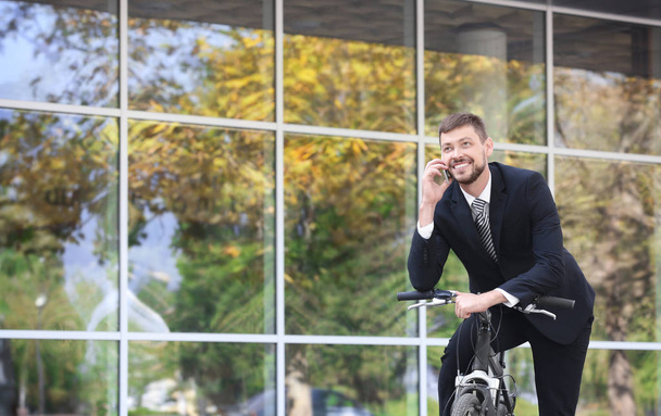 Handsome businessman with bicycle - Φωτογραφία, εικόνα