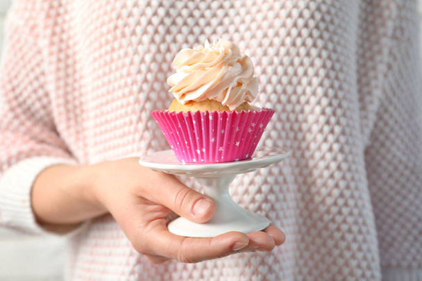 Woman holding stand with delicious cupcake - Fotografie, Obrázek