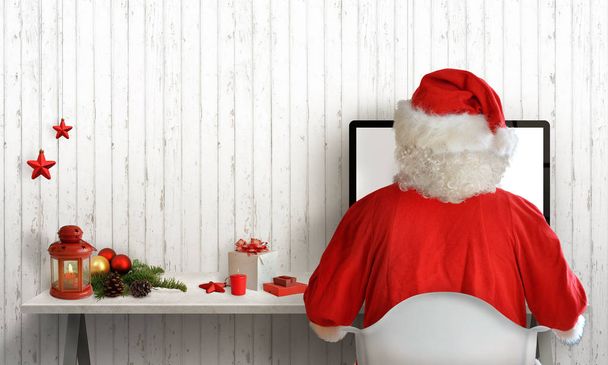 Vánoční čas v místnosti Santa Claus. Santa odpovědi na dopisy v počítači. Volné místo pro pozdrav textu. Bílá dřevěná stěna v pozadí. - Fotografie, Obrázek