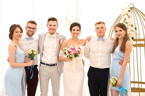 Happy beautiful couple with best men and bridesmaids on wedding day, indoors - 写真・画像