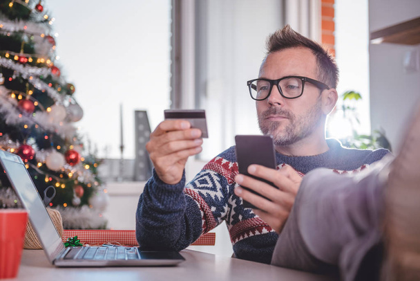 man shopping online at Christmas time - Photo, Image