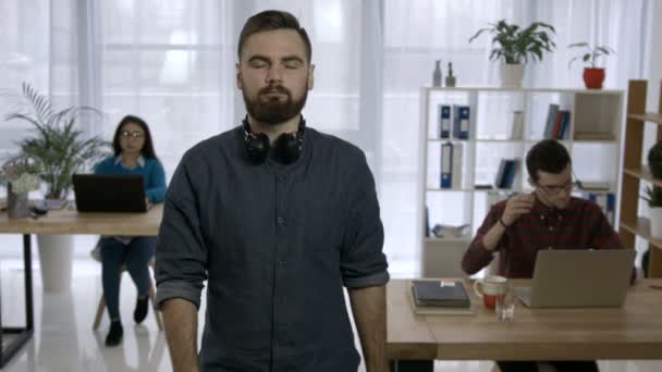 Portrait of young hipster with beard at workplace - Filmati, video