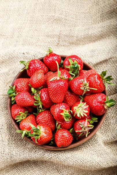 strawberry in a clay plate  - Fotó, kép