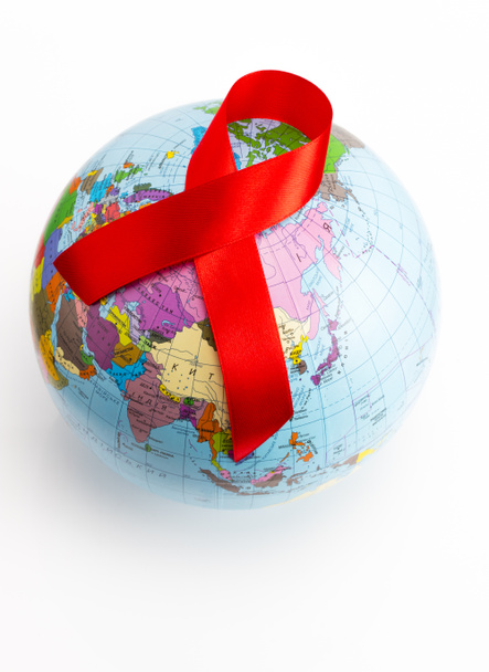 closeup a world globe with a red ribbon for the fight against AI - Photo, Image