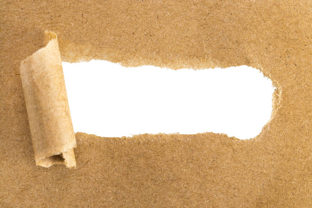 holes in brown paper with torn sides over paper background with  - Photo, Image