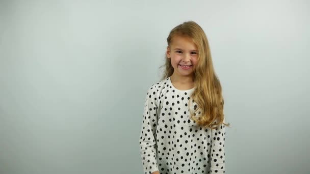 Beautiful blonde little girl smiling and gesturing. Slow motion of yes gesture by cute child.  - Filmmaterial, Video