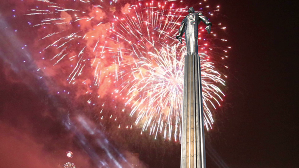 Fireworks over the Monument to Yuri Gagarin (42.5-meter high pedestal and statue), the first person to travel in space. It is located at Leninsky Prospekt in Moscow, Russia. The pedestal is designed to be reminiscent of a rocket exhaust  - Footage, Video