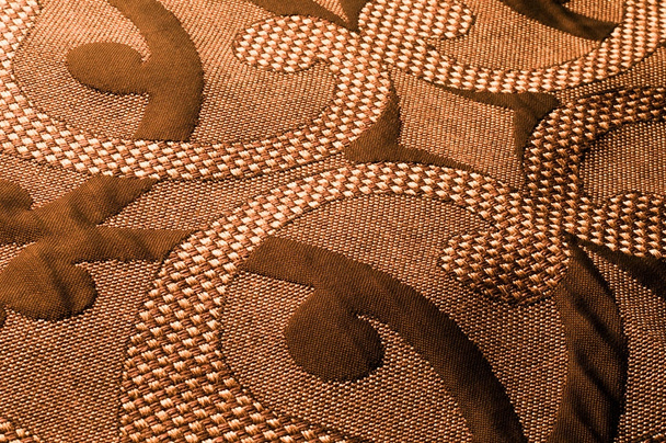 Textur, Hintergrund, Muster. Stoff Tweed Baumwolle goldbraun mit floralem Muster - Foto, Bild