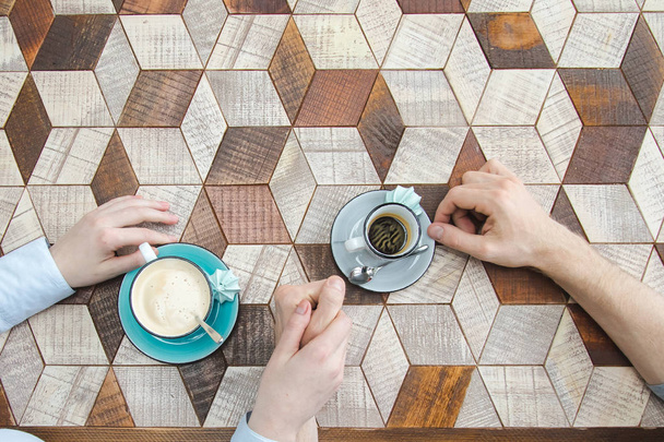 Top view couple holding by hands drinking coffee - Photo, Image