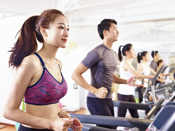 asian young people working out on treadmill - Photo, Image
