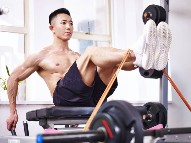 asian bodybuilder exercising in gym - Fotó, kép