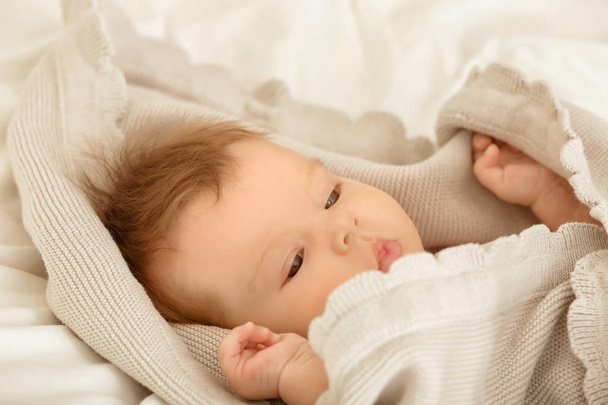 Cute little baby lying on bed  - Foto, afbeelding