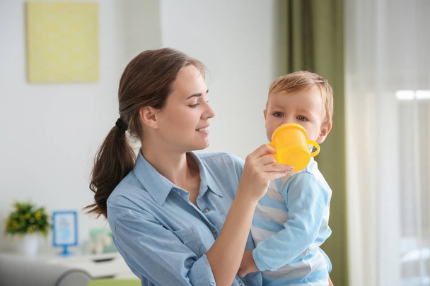 Woman feeding her baby at home - Photo, Image