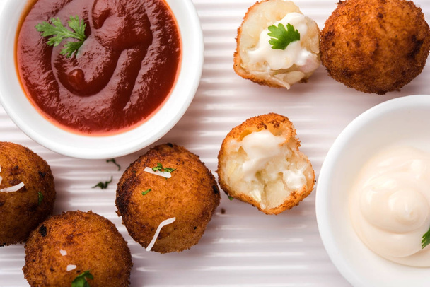 Fried potato cheese balls or croquettes with tomato ketchup. Selective focus - Photo, Image