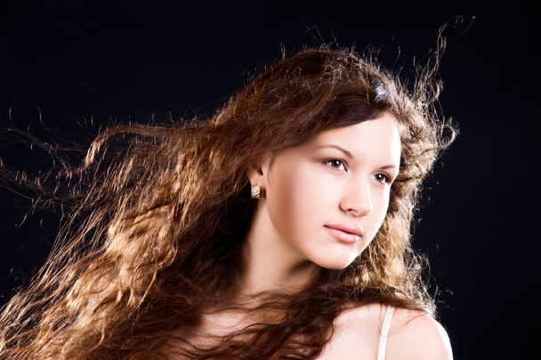 Young woman with long hair portrait - 写真・画像