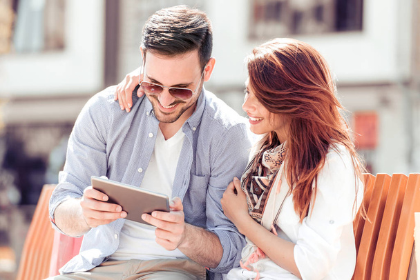 Šťastný mladý pár v digitální tabletu venku. - Fotografie, Obrázek