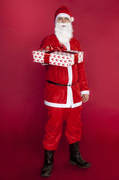 Santa Claus gives a beautiful gift - Photo, Image