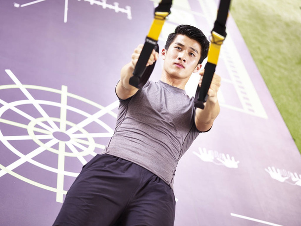 young asian adult working out in gym - Photo, Image